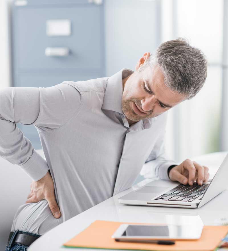 man at desk with aching back